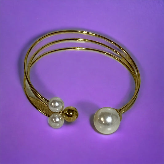 Pulsera con esferas tipo Perlas y doradas en acero inoxidable